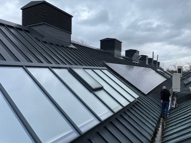 Chartered building surveyor inspecting a commercial roof during a dilapidation building inspection.